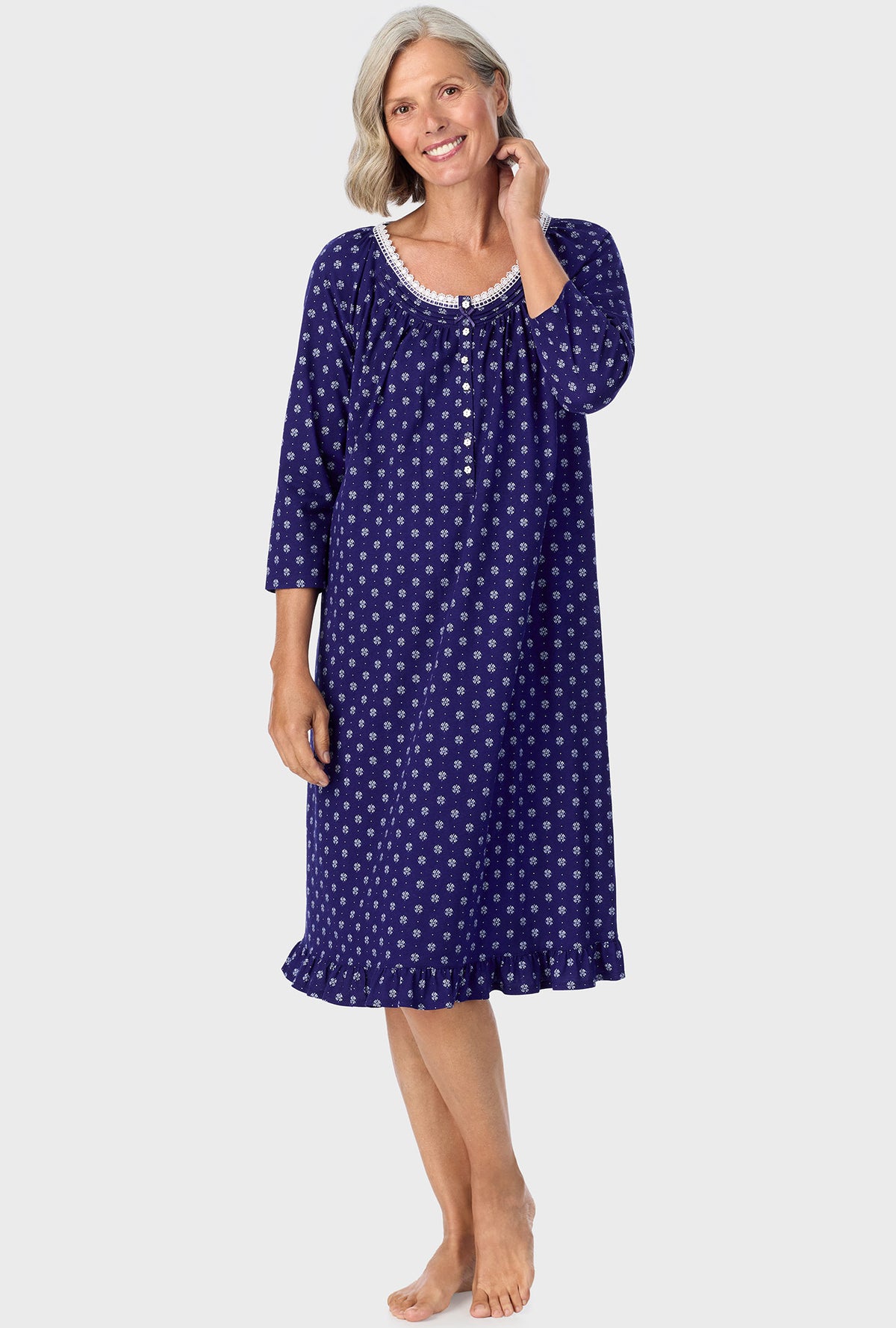 A lady wearing navy quarter sleeve nightgown with navy geo print.