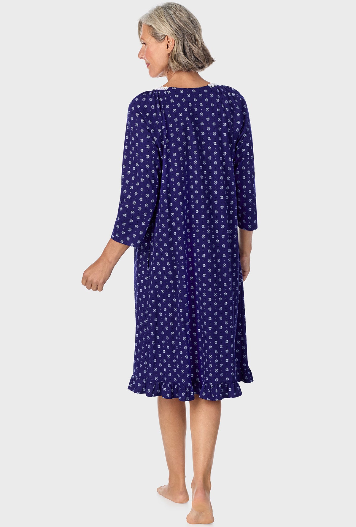 A lady wearing navy quarter sleeve nightgown with navy geo print.