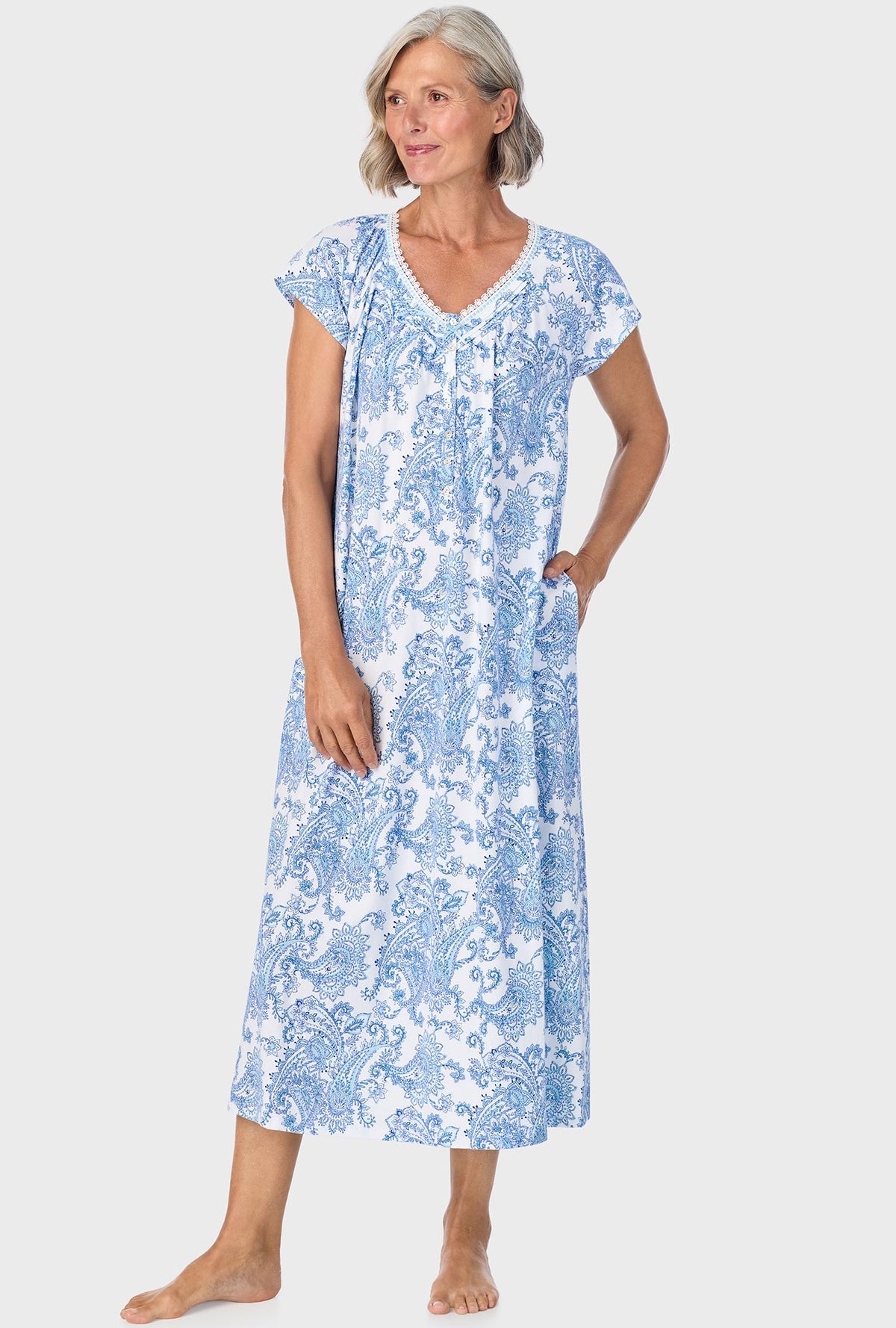 A lady wearing blue cap sleeve nightgown with cool multi paisley print.