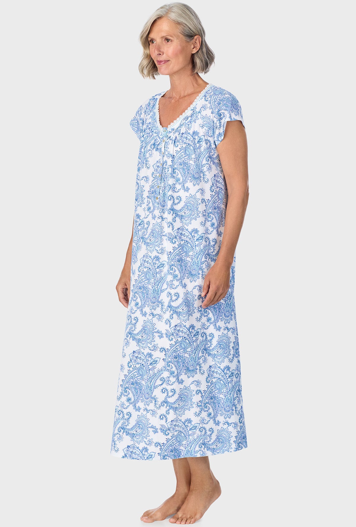 A lady wearing blue cap sleeve nightgown with cool multi paisley print.