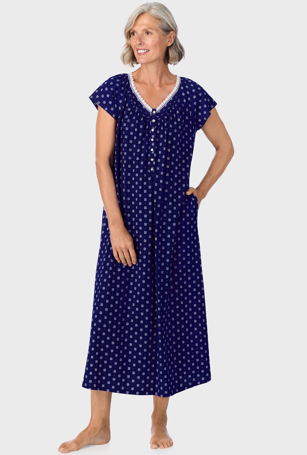 A lady wearing navy cap sleeve nightgown with navy geo print.