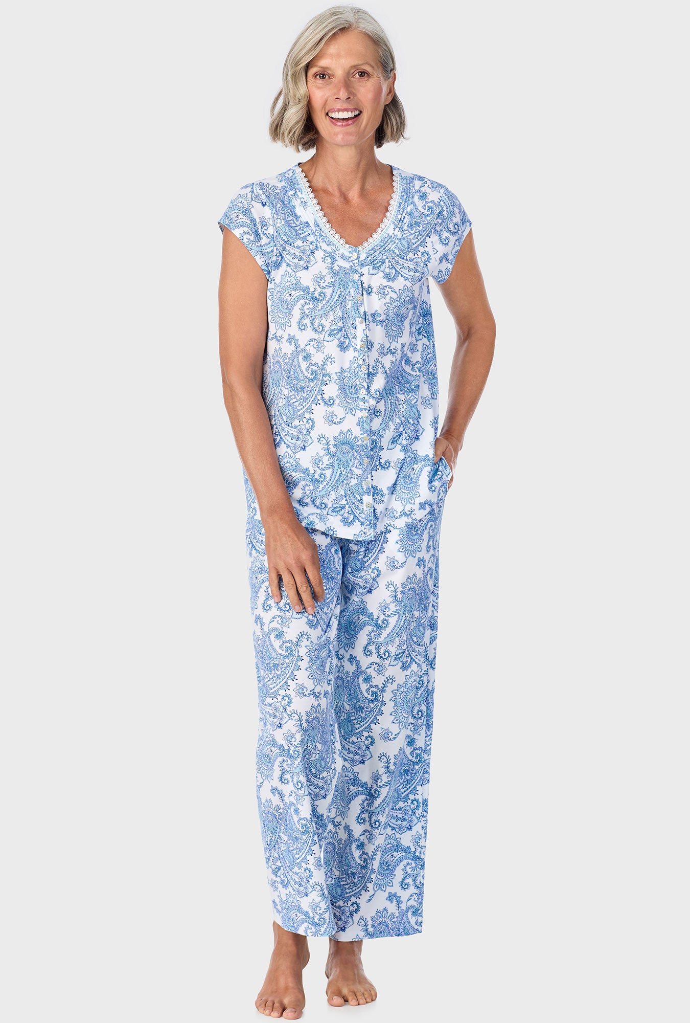 A lady wearing blue short sleeve pajama set with cool multi paisley print.