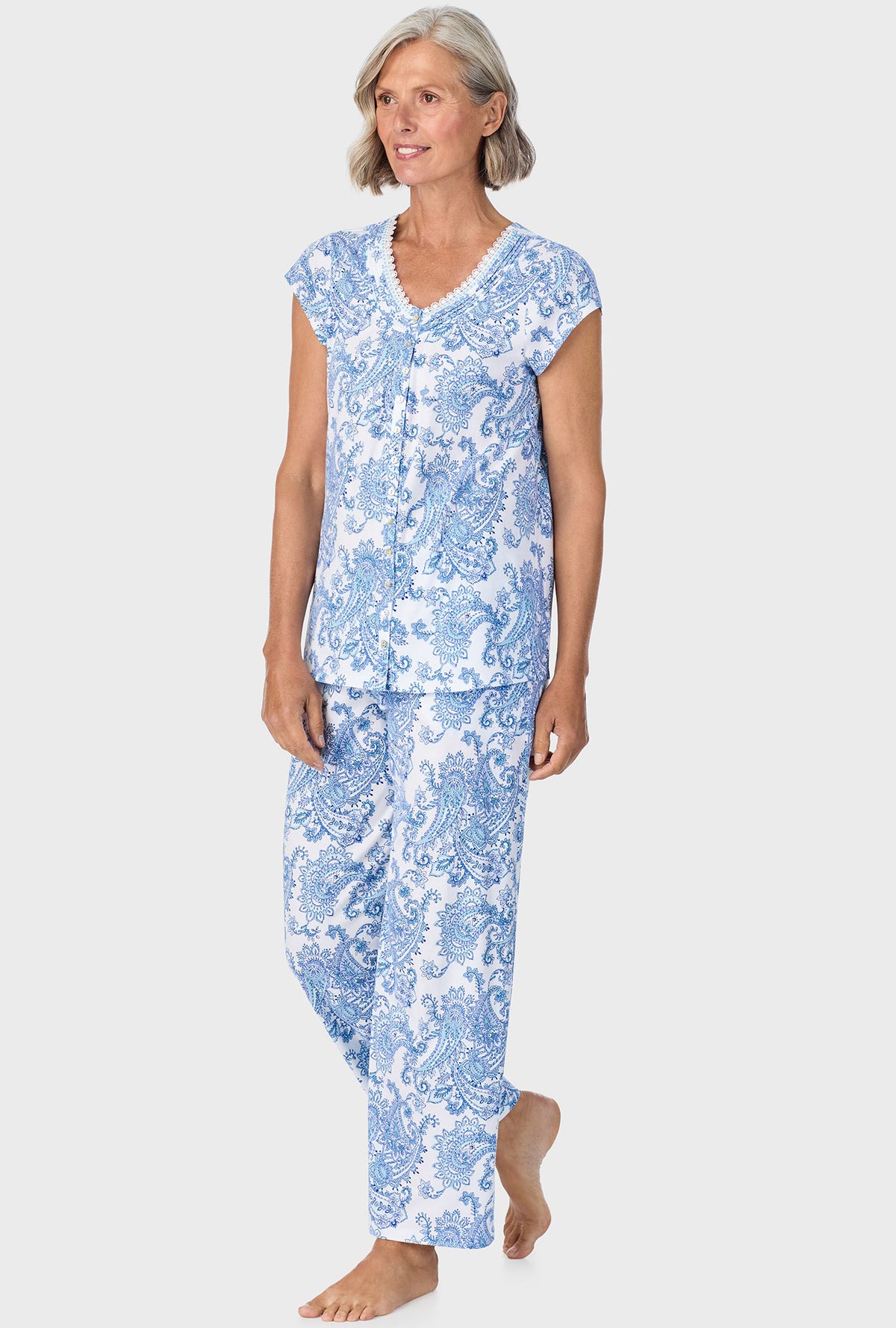 A lady wearing blue short sleeve pajama set with cool multi paisley print.