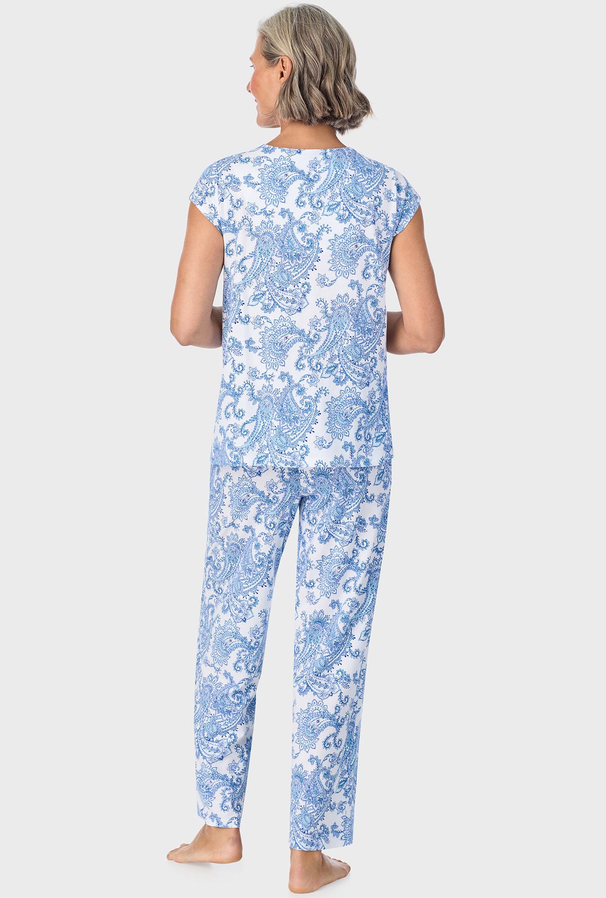 A lady wearing blue short sleeve pajama set with cool multi paisley print.