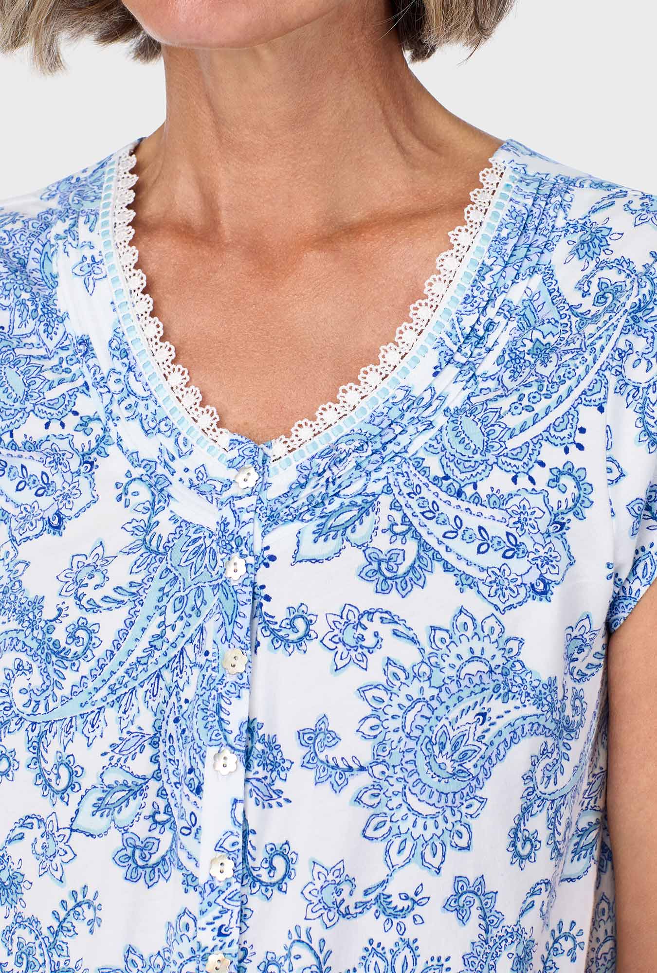 A lady wearing blue short sleeve pajama set with cool multi paisley print.