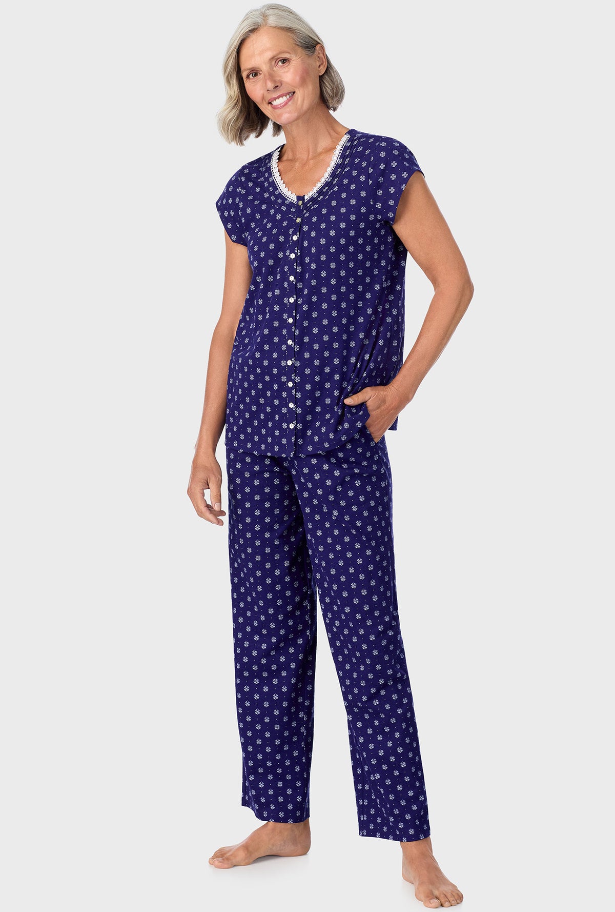 A lady wearing navy cap sleeve long pant pj set with navy geo print.